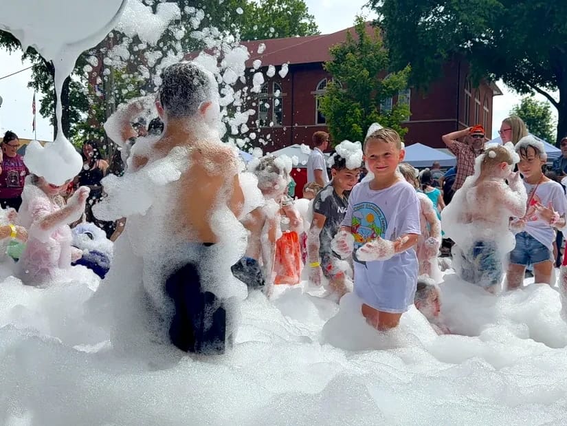 Kids playing in a giant pile of party foam