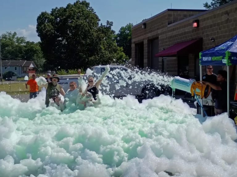 Kids playing as the foam cannon sprays across a Chattanooga foam party