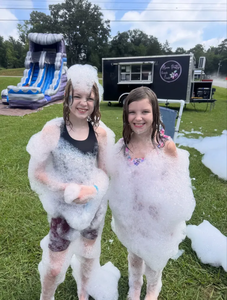Two girls covered head to toe in foam at a Chattanooga foam party